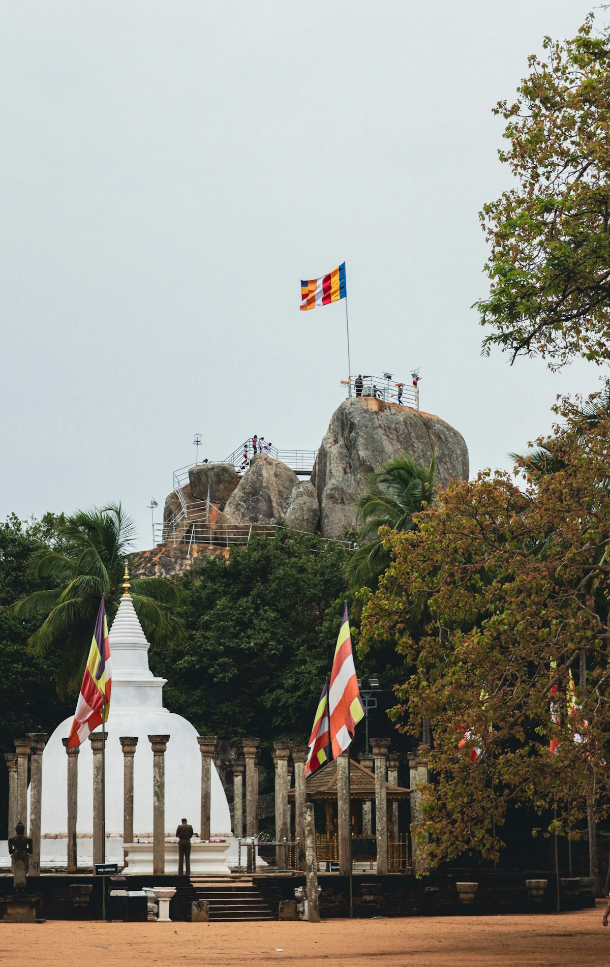 Sri Lankan flag flying in front of Mihintale rock formation, north-central Sri Lanka