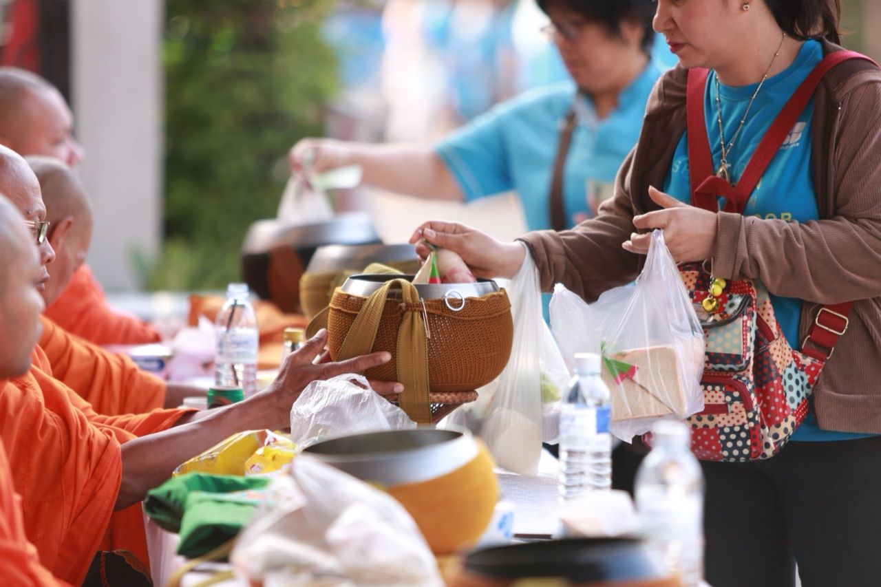 Women offering food to Buddhist monks - Anuradhapura pilgrimage city food culture