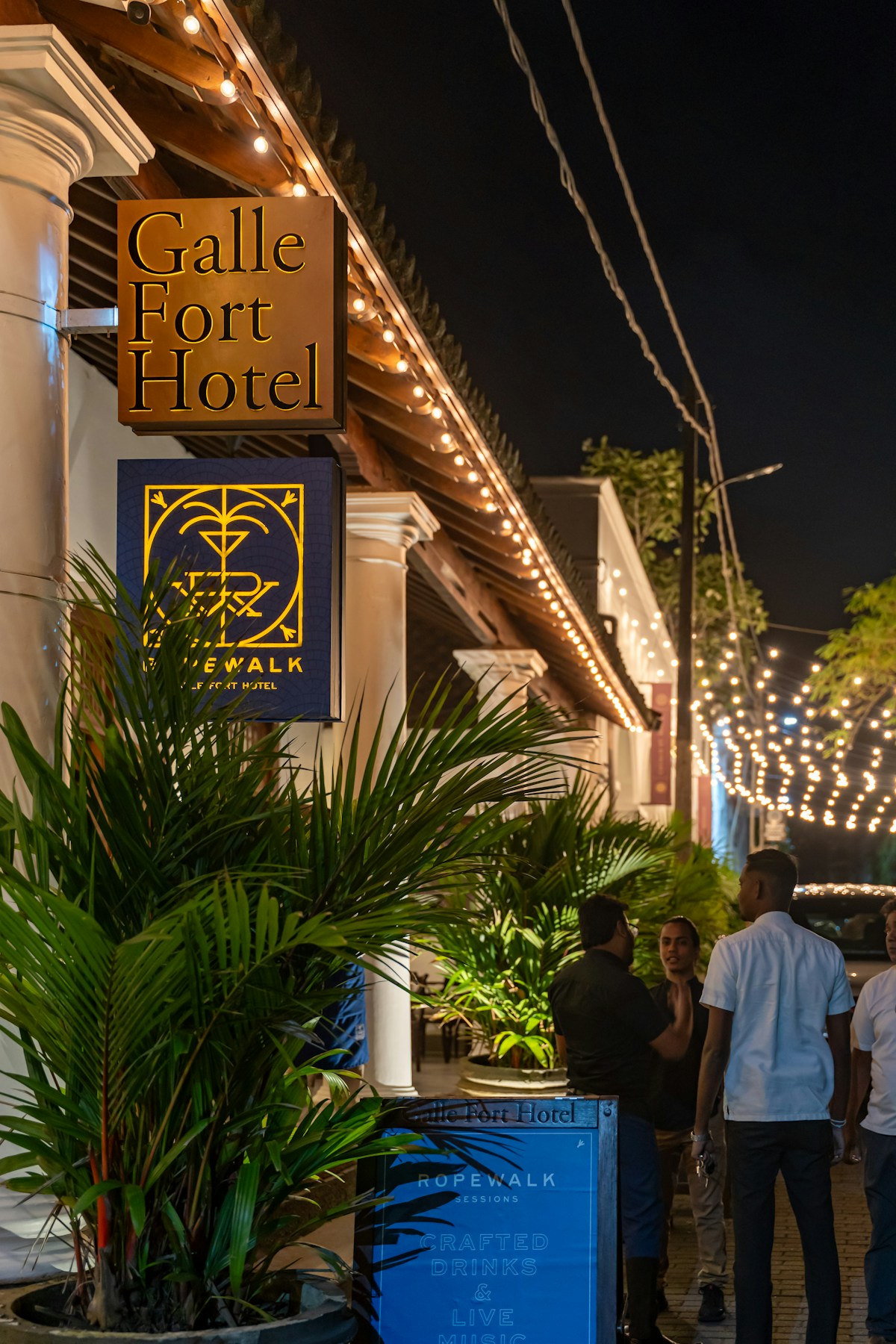 Galle Fort Hotel sign lit up at night on a colonial street inside Galle Fort, Sri Lanka