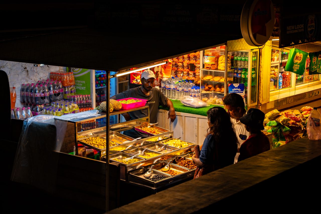Busy Colombo night food stall with a variety of dishes