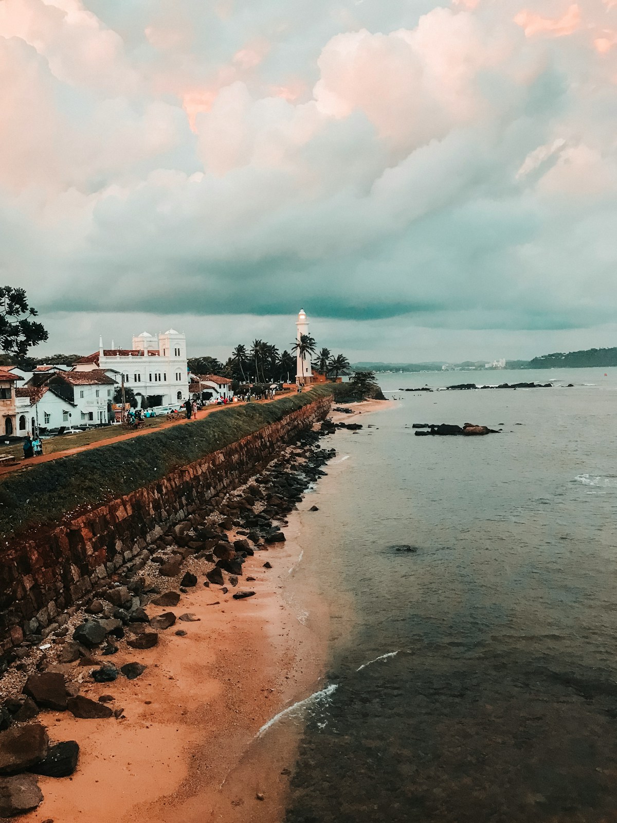 White painted Galle Fort lighthouse against cloudy sky, southern Sri Lanka