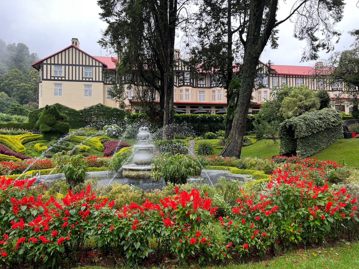 The Grand Hotel Nuwara Eliya with its colonial Tudor-style facade and formal garden with fountain, Sri Lanka