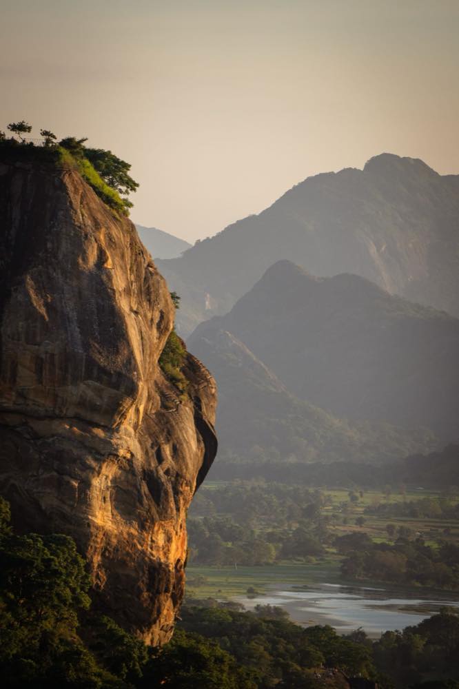Rock cliff and forested valley in the Sigiriya area at golden hour