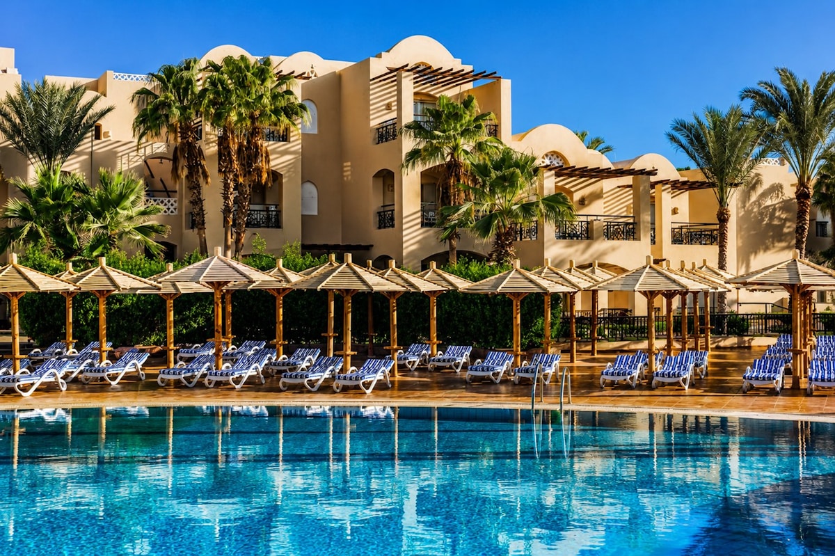 Luxury resort pool with sun loungers under palm trees, Jaffna area