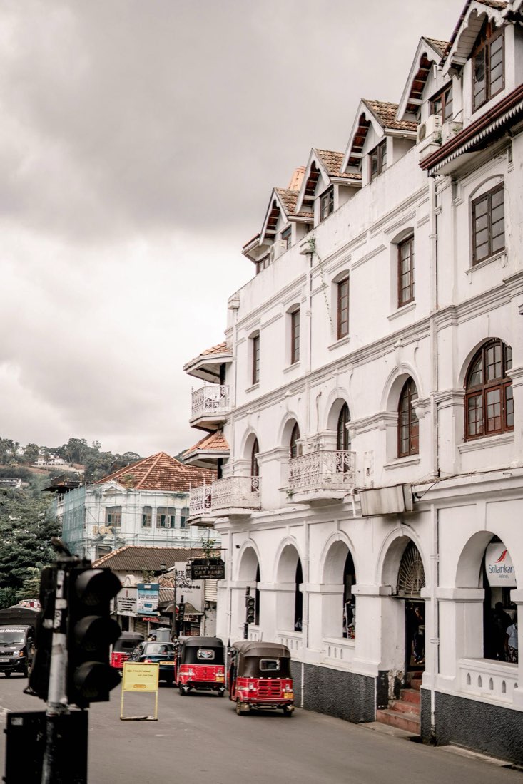 Historic buildings and tuk-tuks on a Kandy street