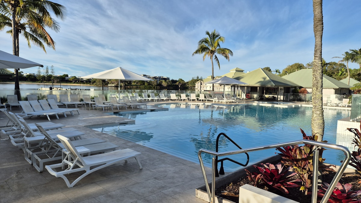Resort swimming pool with lounge chairs and palm trees, Negombo, Sri Lanka