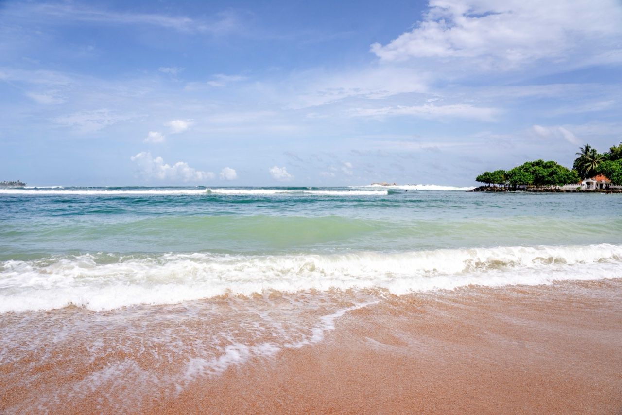 Tropical beach, south coast Sri Lanka - April tourist arrivals fall 22% 2026