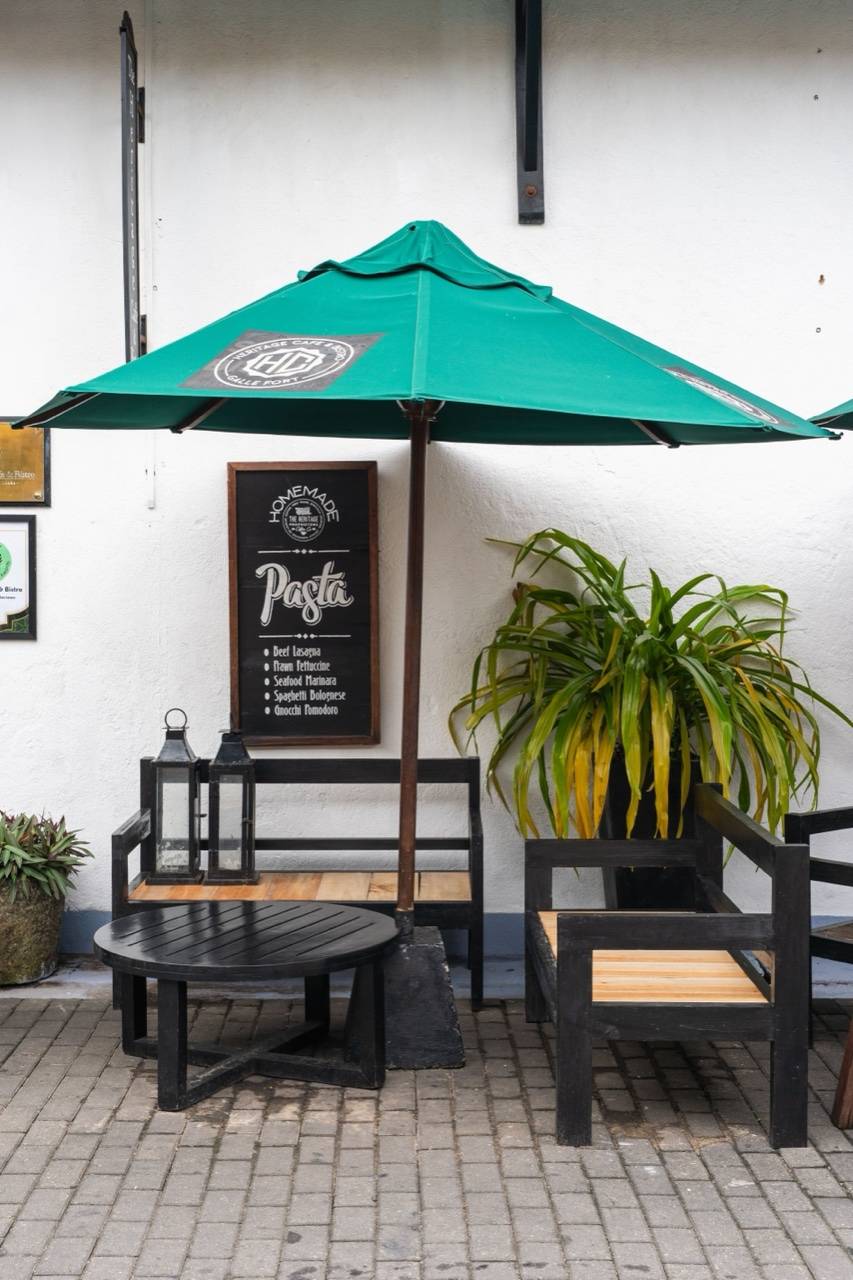 Outdoor cafe with green umbrella, Sri Lanka hill country — Nuwara Eliya food guide