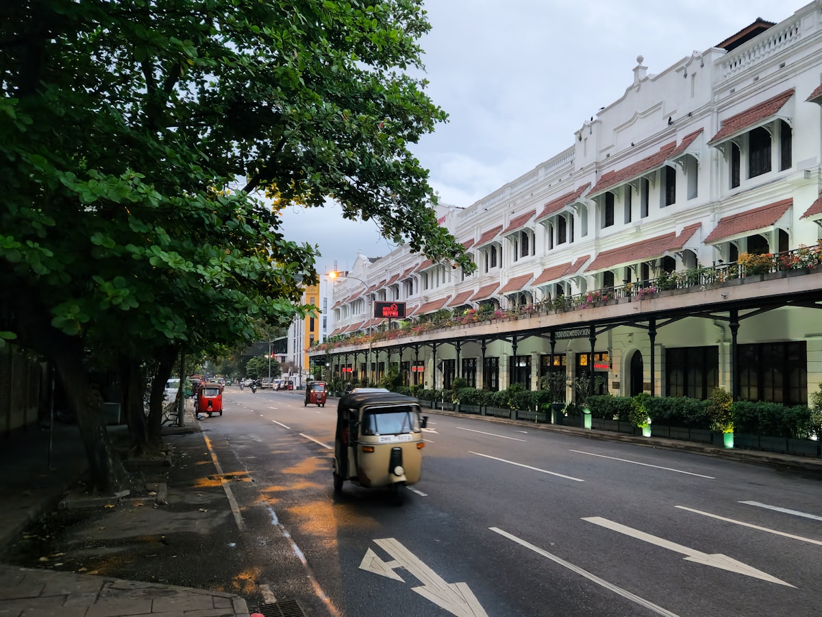 Tuk-tuk on a quiet Colombo street lined with colonial-era buildings, Sri Lanka
