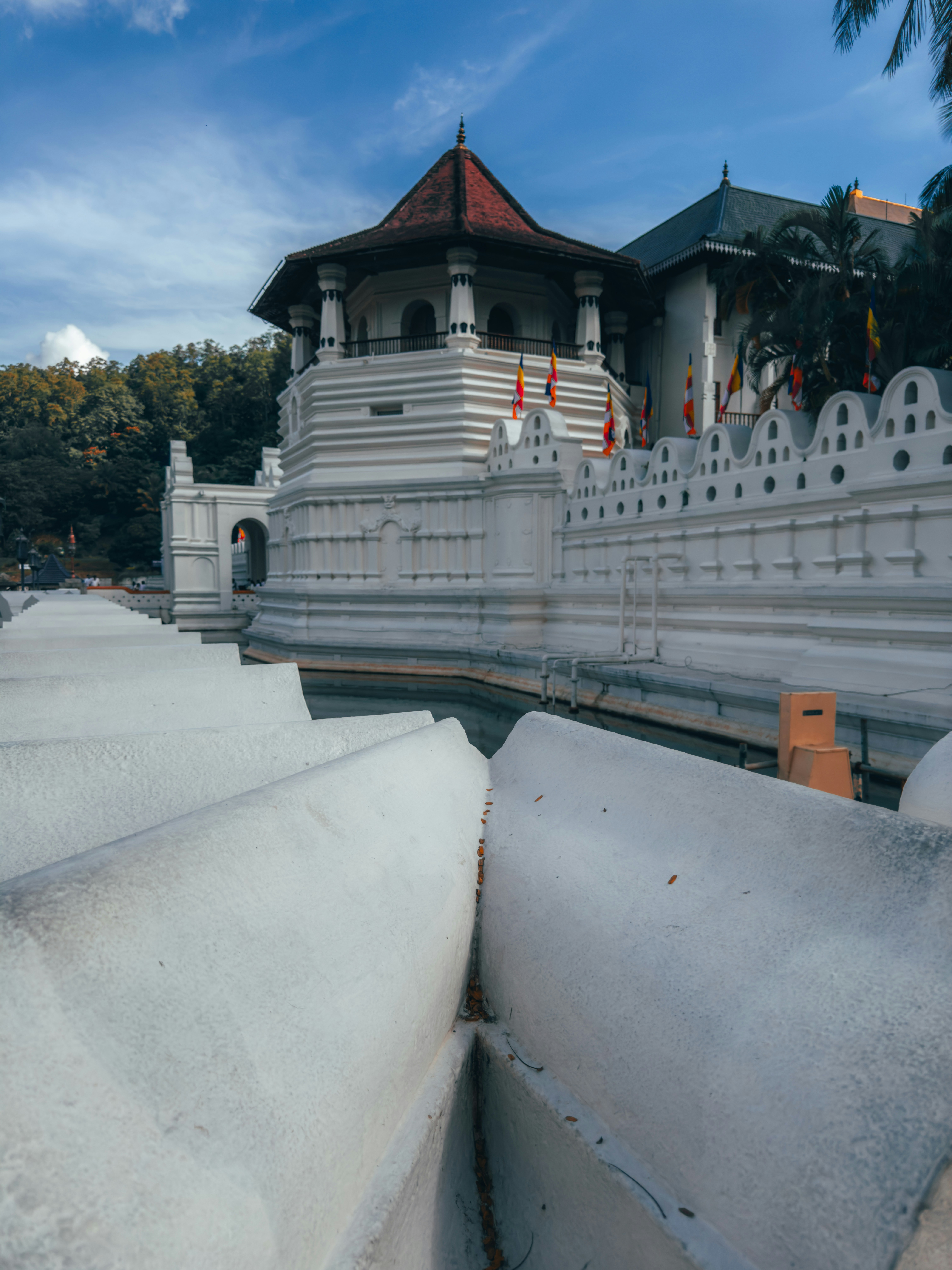 Temple of the Tooth Relic (Sri Dalada Maligawa) with white walls on Kandy Lake, Sri Lanka