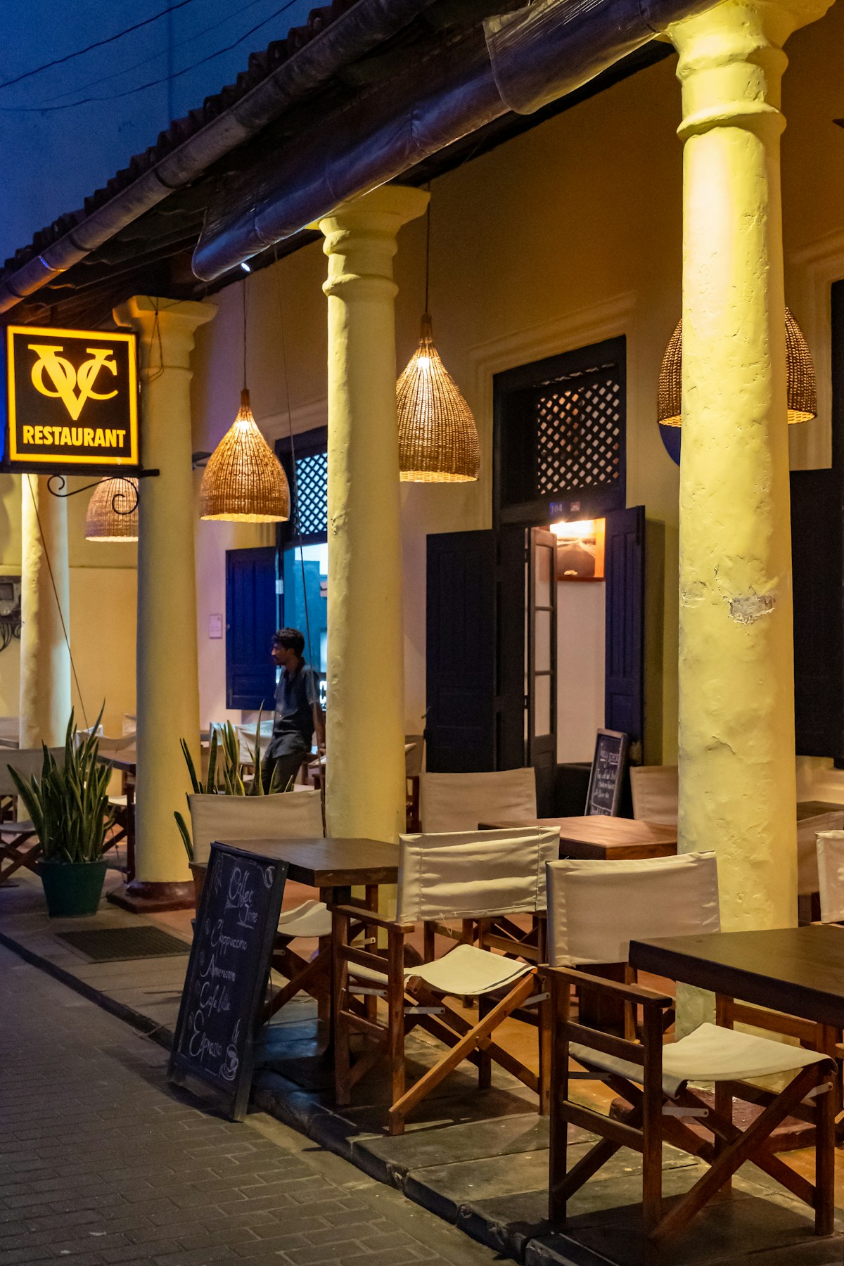 Outdoor restaurant with warm lights and pillars, Sigiriya area