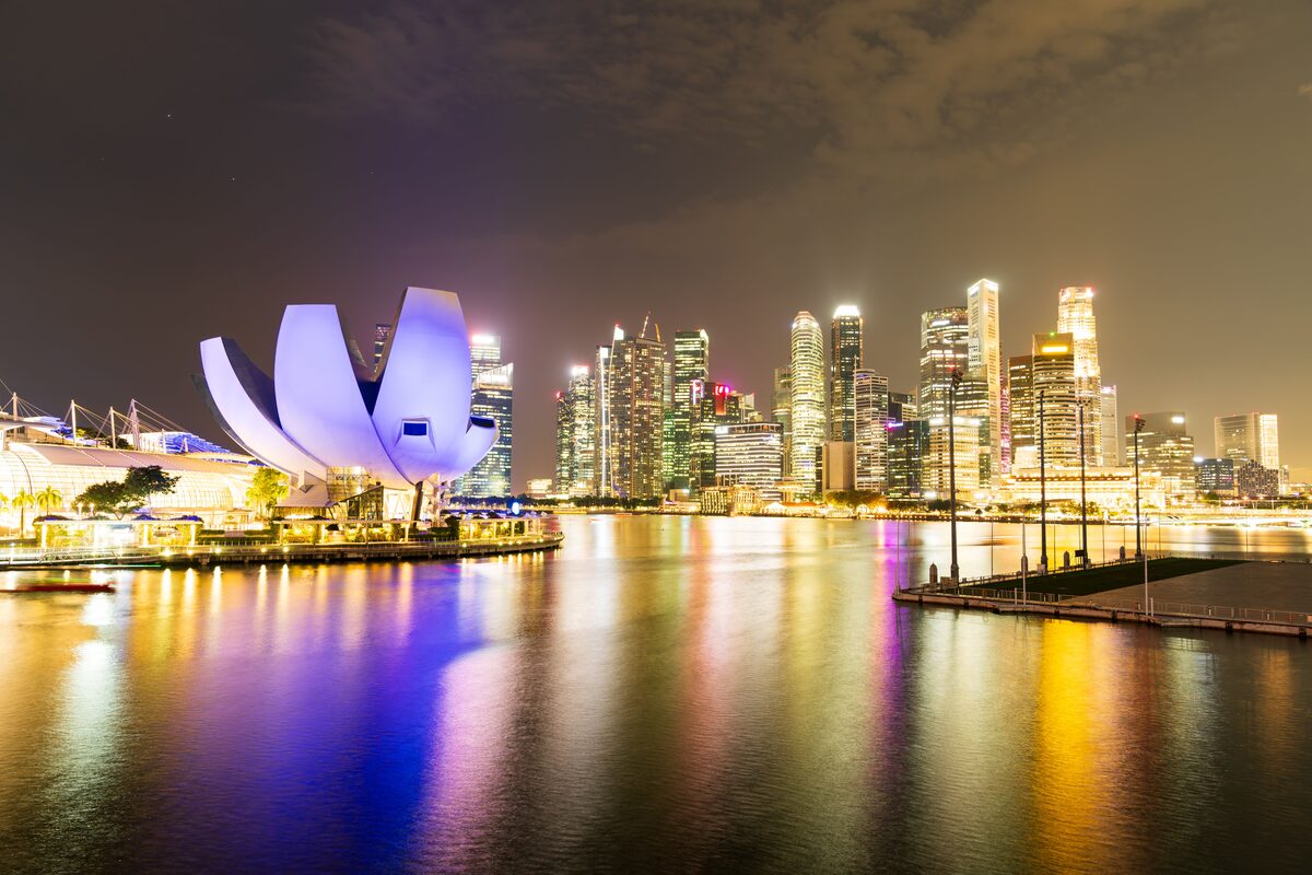 Singapore Marina Bay Sands illuminated at night with city skyline reflection