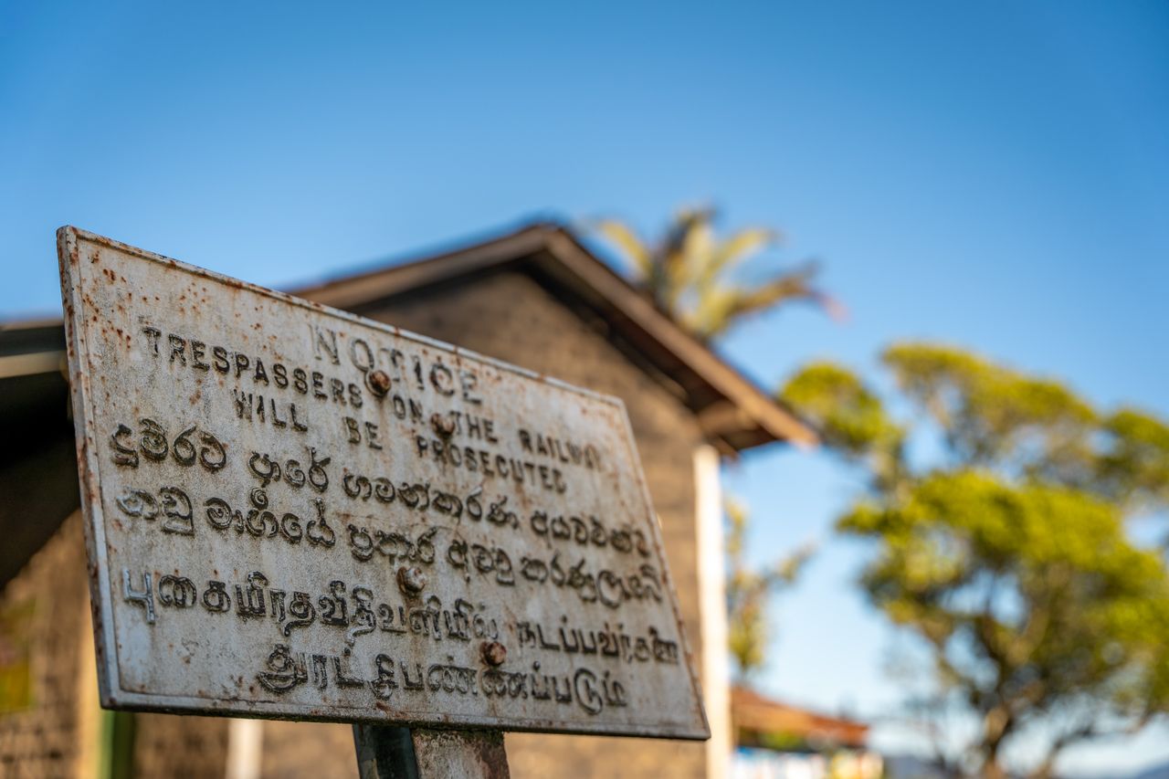 Weathered notice sign in English, Sinhala and Tamil, Sri Lanka
