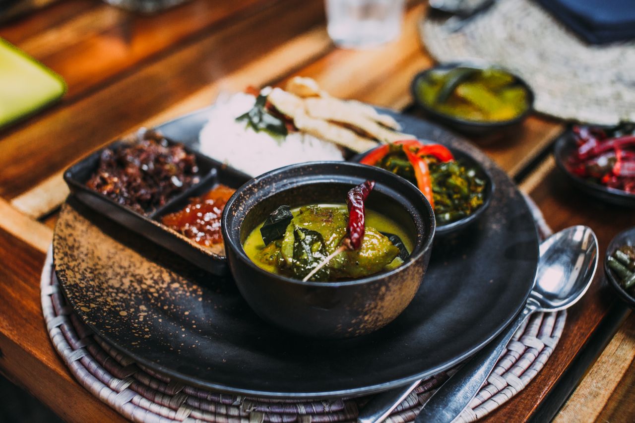 Close-up of a curry dish with chilli peppers and sides