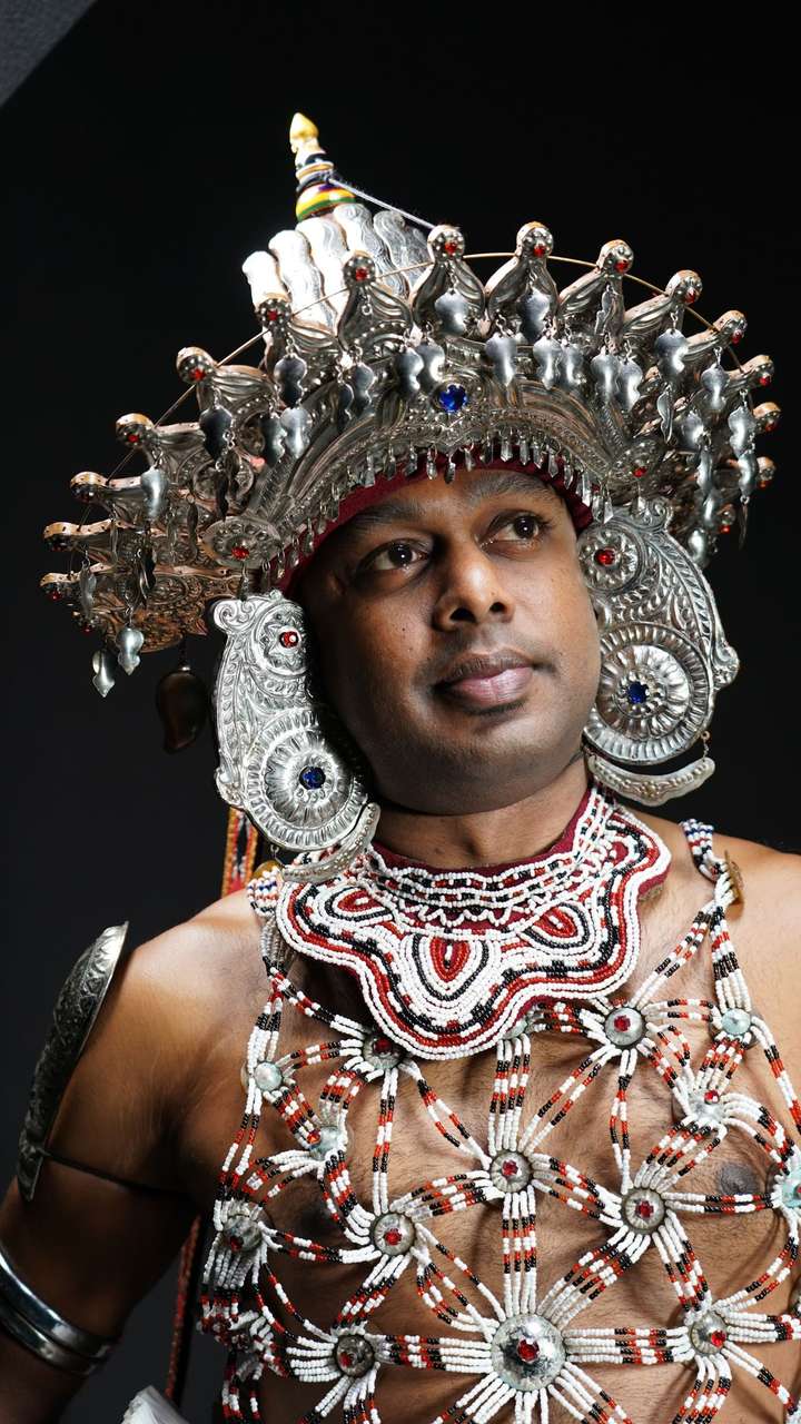 Traditional Kandyan dancer in elaborate ceremonial costume and beaded headdress, Sri Lanka
