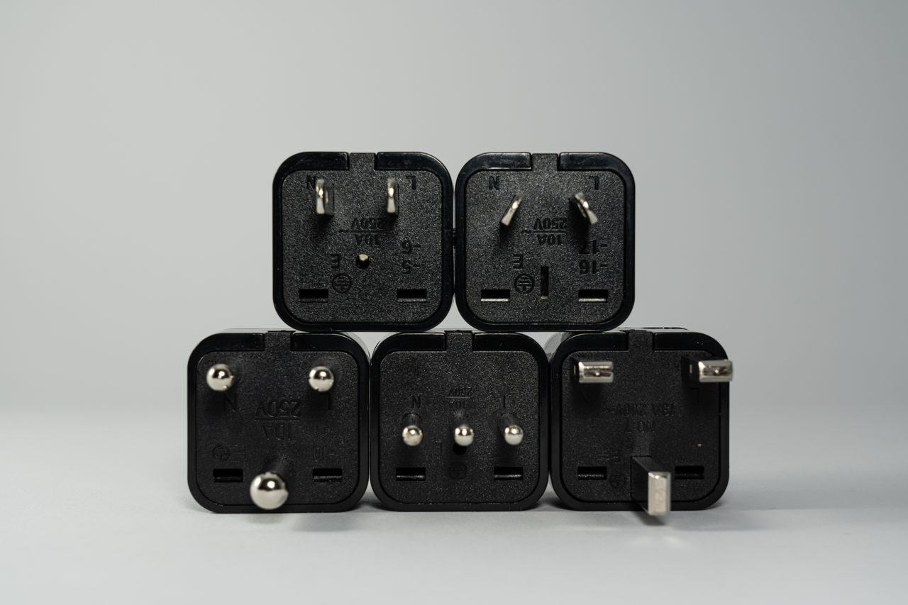 Black international power plug adapters with different pin layouts