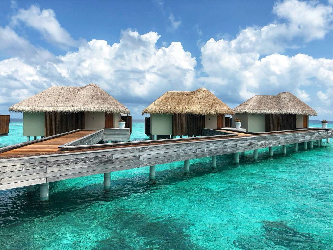 Luxury overwater bungalows on turquoise lagoon in the Maldives