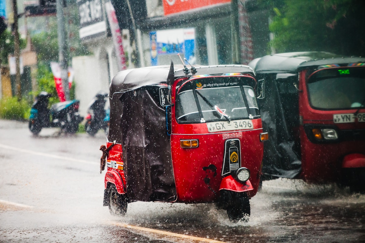 Tuk-tuk in heavy rain on a Sri Lanka street — June monsoon season