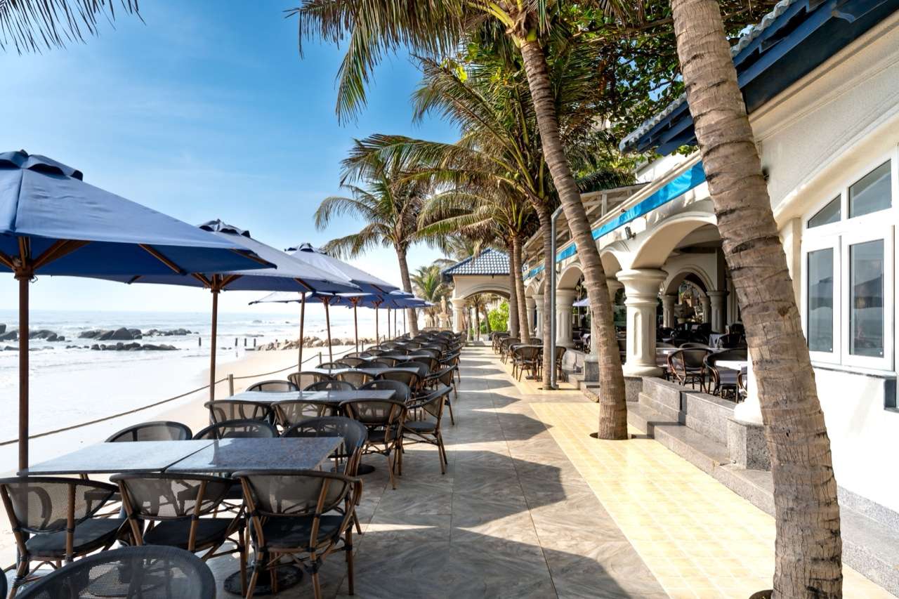 Beachfront restaurant patio with palm trees, Sri Lanka - Tangalle food guide