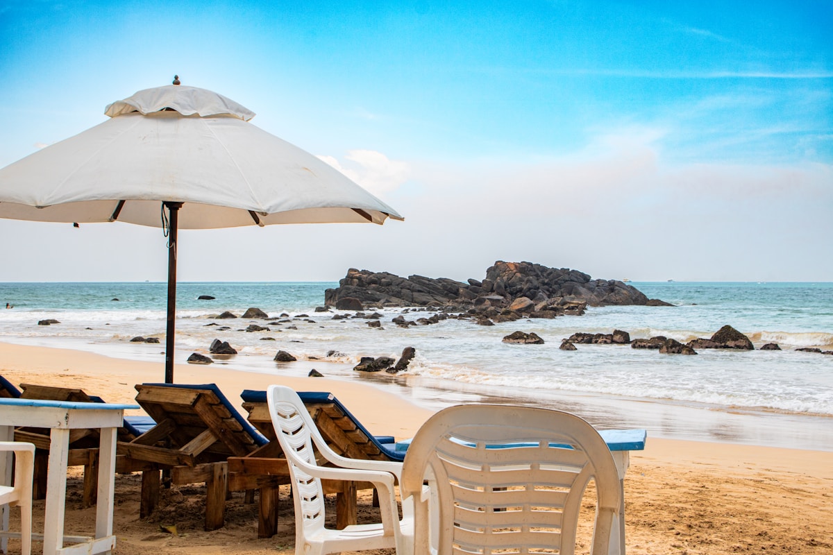 Beach scene with sun loungers and waves, Tangalle, southern Sri Lanka