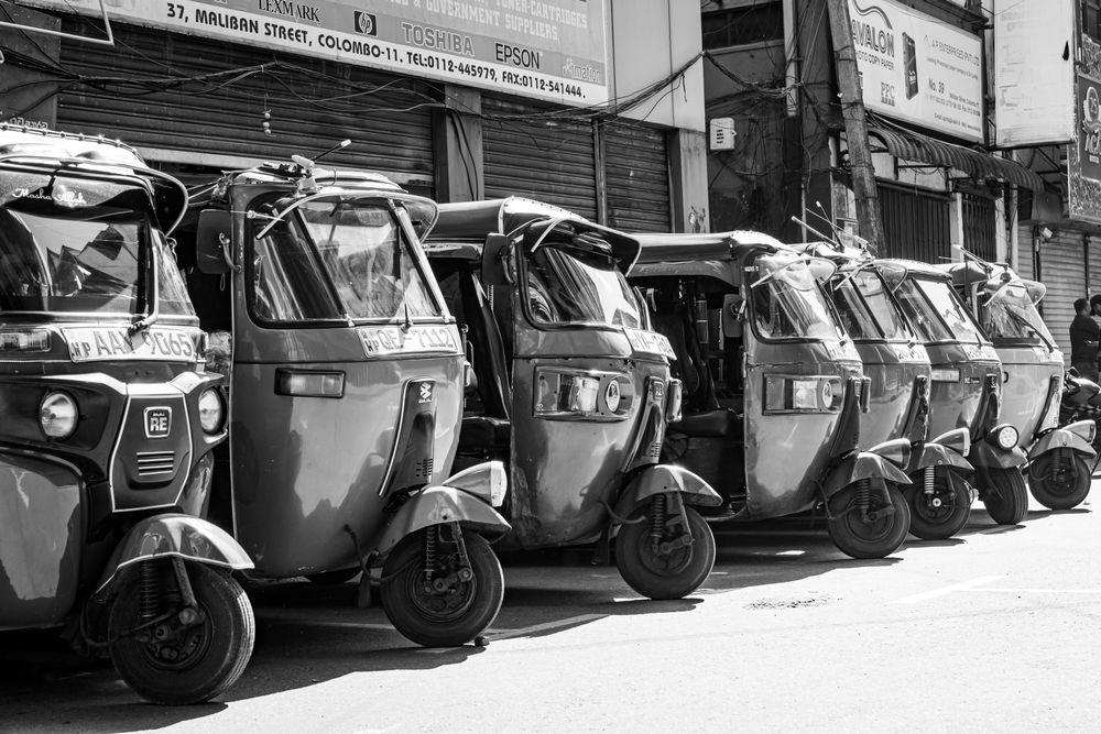 Tuk-tuks parked on a busy Colombo street, Sri Lanka