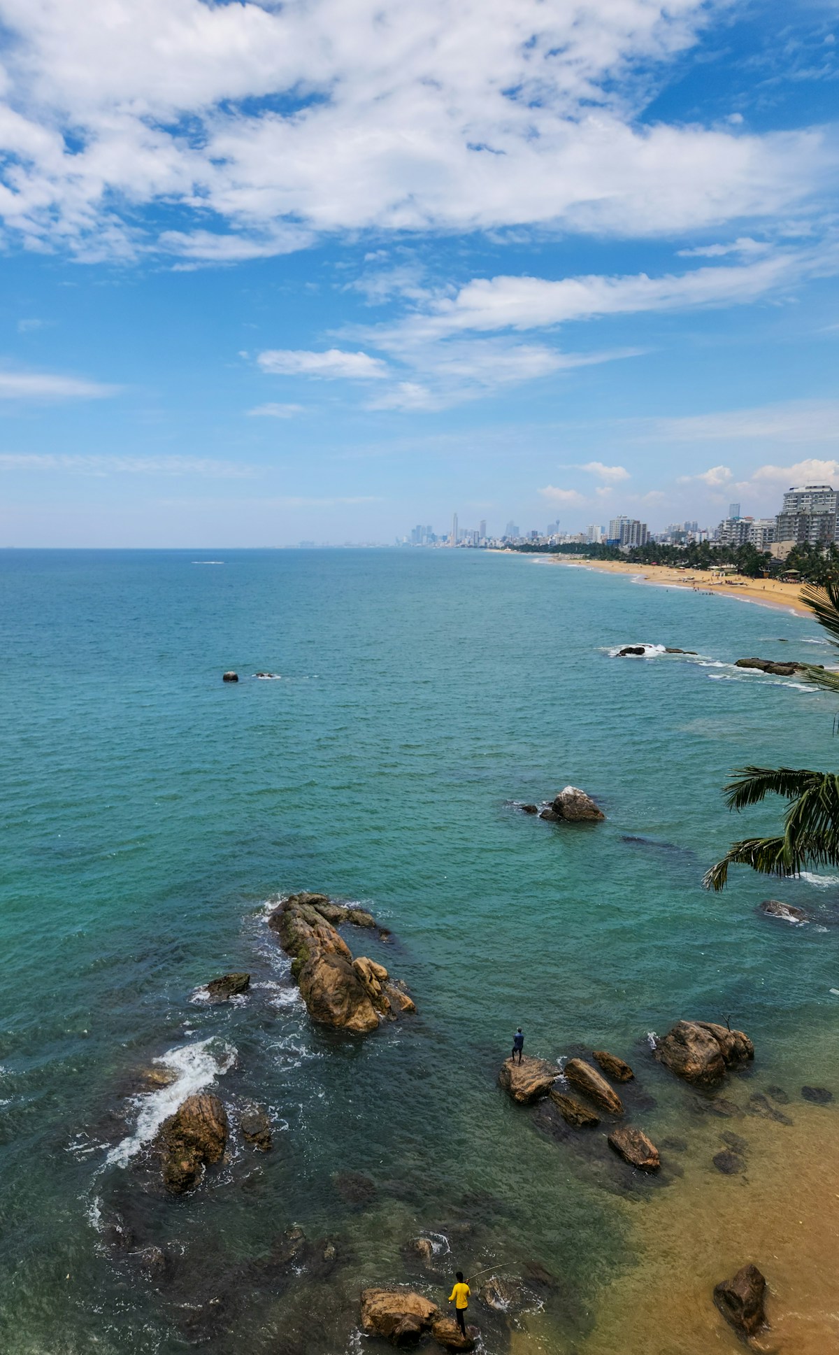 Unawatuna horseshoe bay with clear blue water and palm-fringed beach, southern Sri Lanka